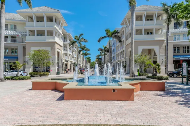 a front view of multiple houses with yard