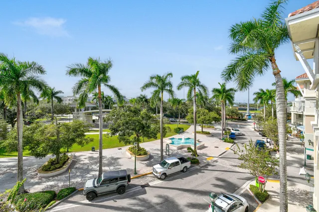 a view of a parking space with garden from a patio