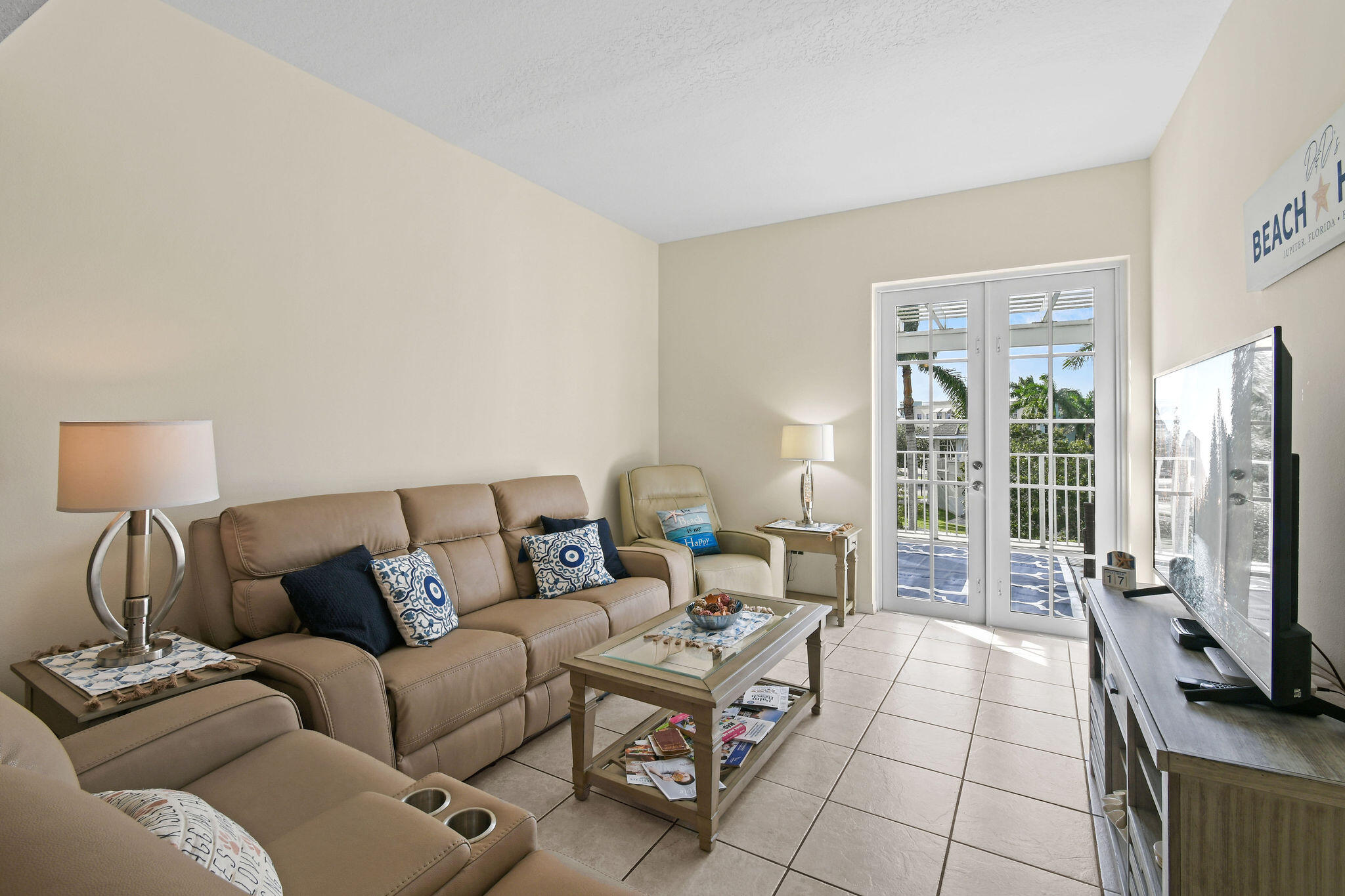 1200 Town Center Drive, Unit 326 Jupiter, FL 33458 - Photo 5 of 44 a living room with furniture a flat screen tv and a fireplace
