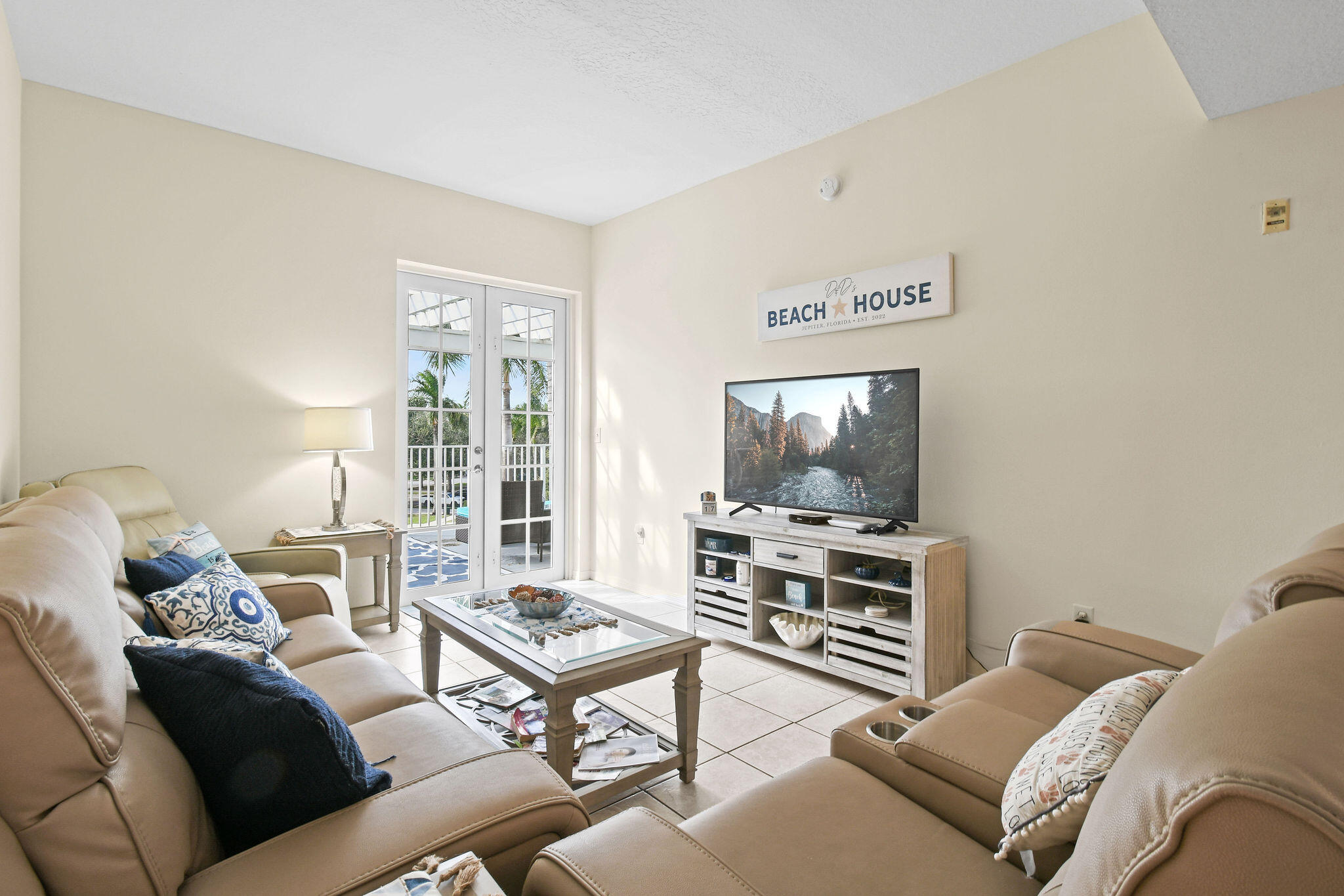 1200 Town Center Drive, Unit 326 Jupiter, FL 33458 - Photo 6 of 44 a living room with furniture and a flat screen tv