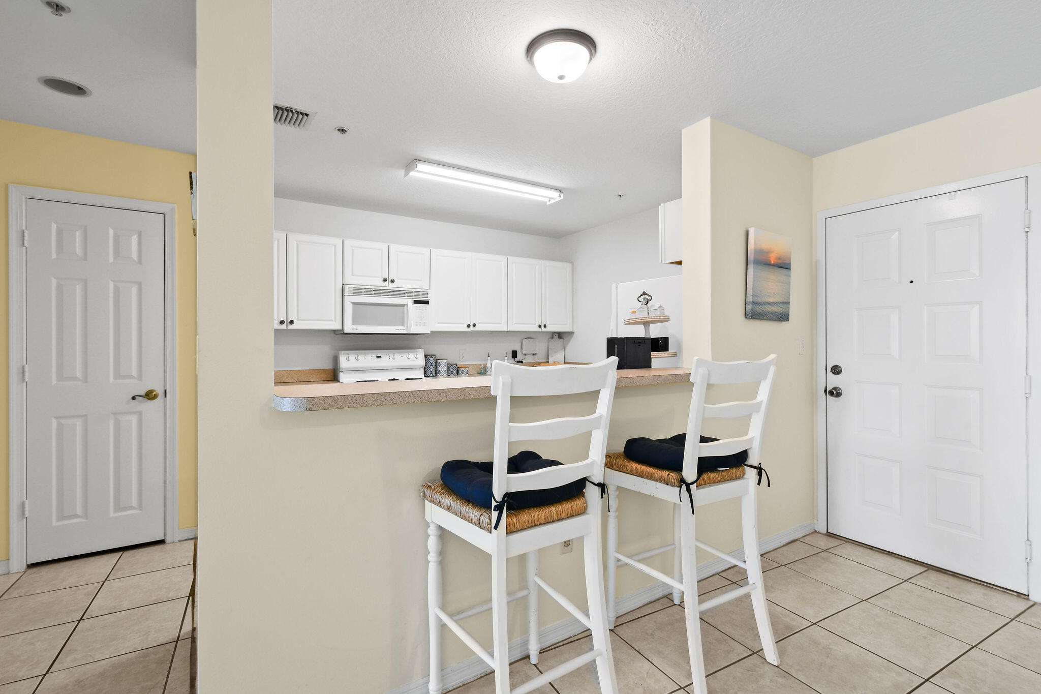 1200 Town Center Drive, Unit 326 Jupiter, FL 33458 - Photo 10 of 44 a kitchen with a refrigerator and white cabinets