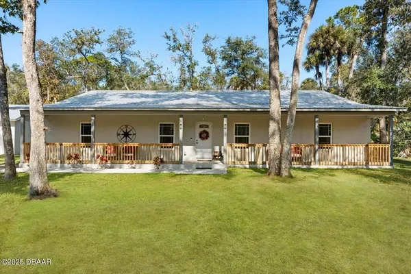 a front view of a house with swimming pool garden and patio