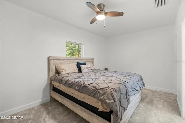 a bedroom with a bed and window