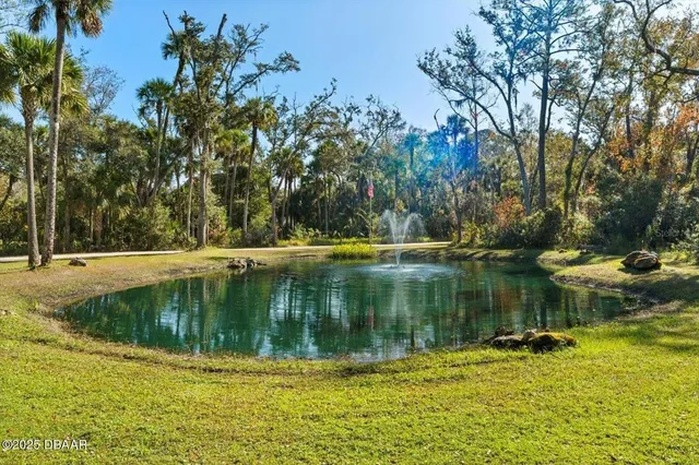 front view of a house with a chairs and table in the patio