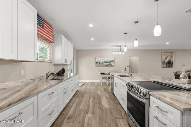 a kitchen with a sink stove and cabinets