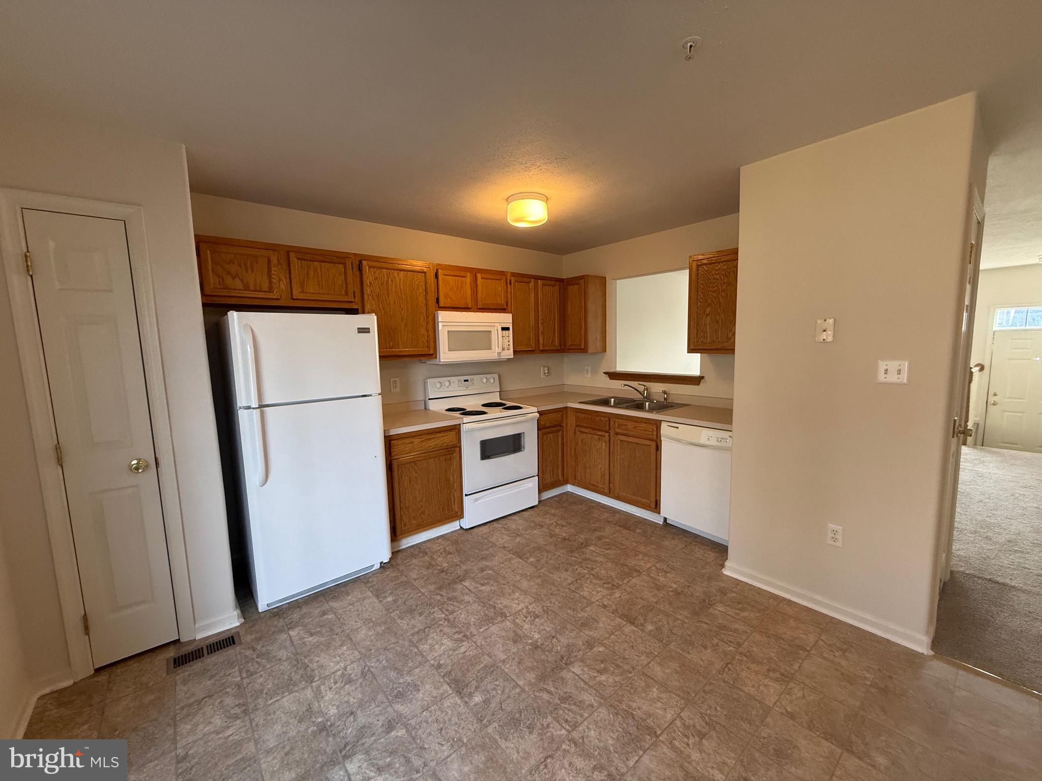 294 Mike Drive Elkton, MD 21921 - Photo 15 of 61 a kitchen with a refrigerator a stove top oven and white cabinets