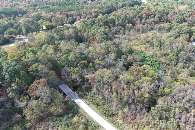 an aerial view of a houses with a yard