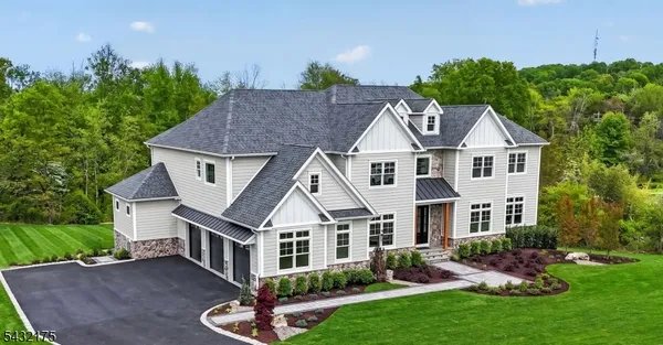 a aerial view of a house with yard and green space