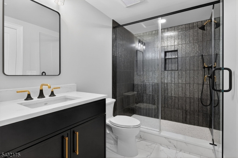 2 Ravinn Lane Warren, NJ 07059 - Photo 25 of 32 a bathroom with a sink vanity mirror and toilet