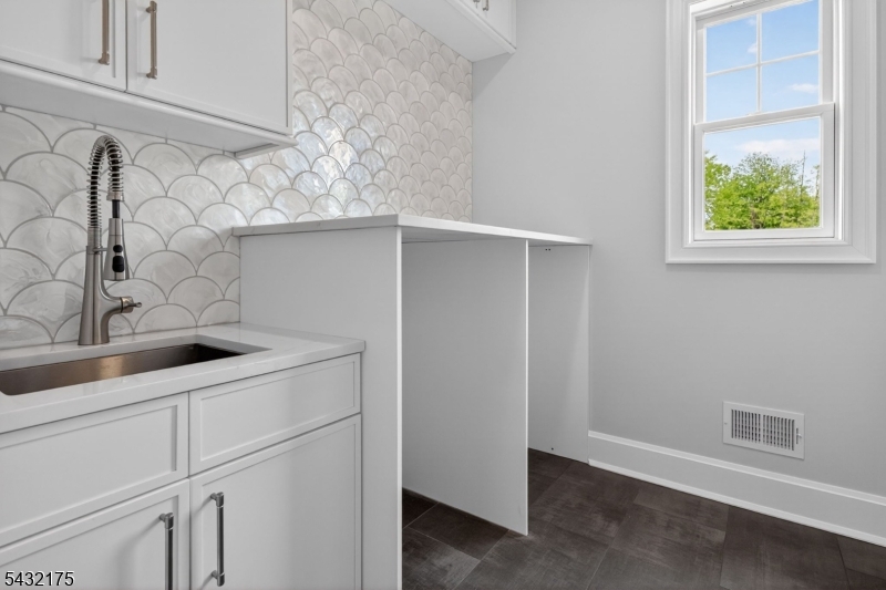 2 Ravinn Lane Warren, NJ 07059 - Photo 28 of 32 a kitchen with white cabinets and a sink
