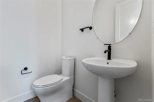 a bathroom with a sink a mirror and toilet