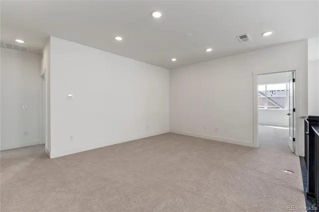 a view of an empty room with windows