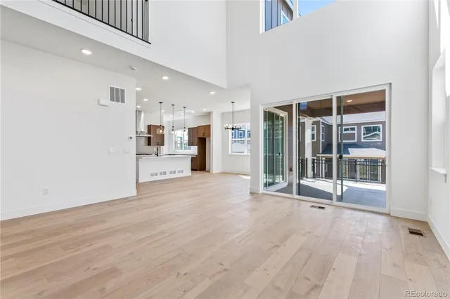 a view of an empty room with a kitchen