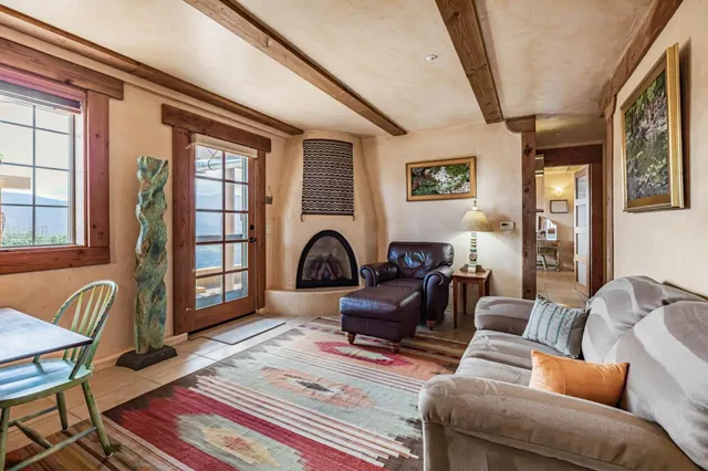 a kitchen with a granite countertop sink and natural light