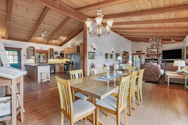 a view of a dining room with furniture wooden floor and a chandelier