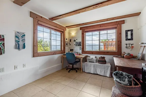 a living room with furniture and a floor to ceiling window