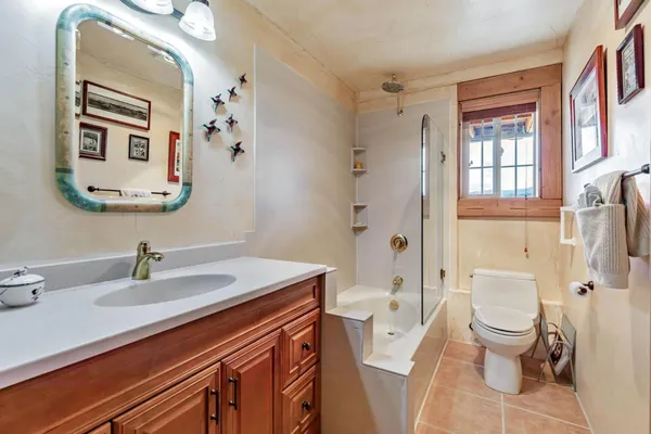 a bathroom with a sink a toilet and shower curtain