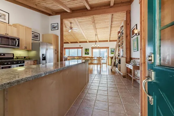 a hallway with a view of living room with furniture