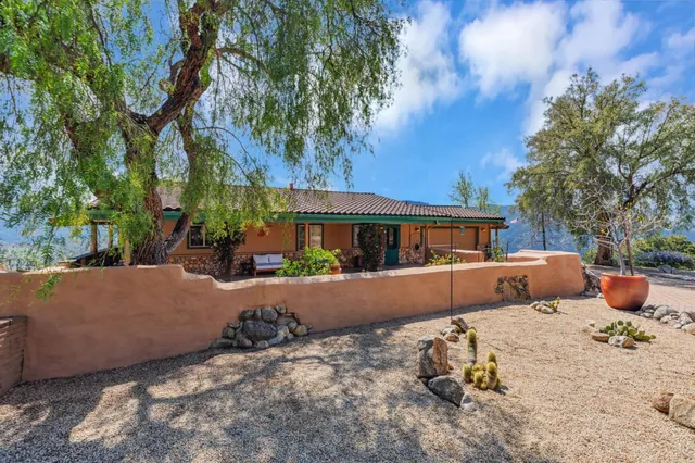a hallway with a view of living room with furniture