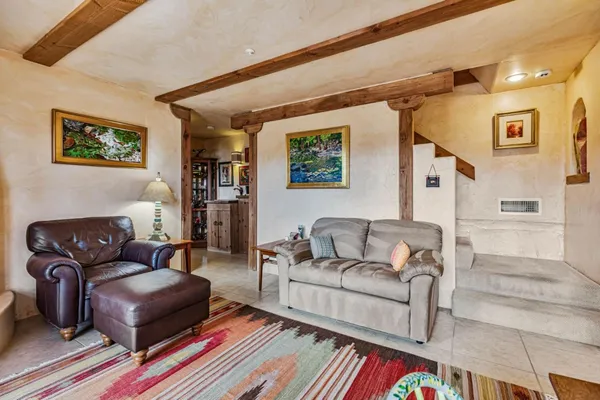 a living room with furniture and wooden floor