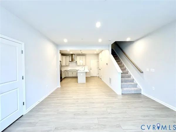 a view of a living room with wooden floor