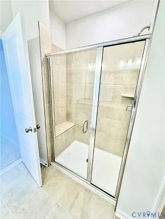 a bathroom with a glass shower door