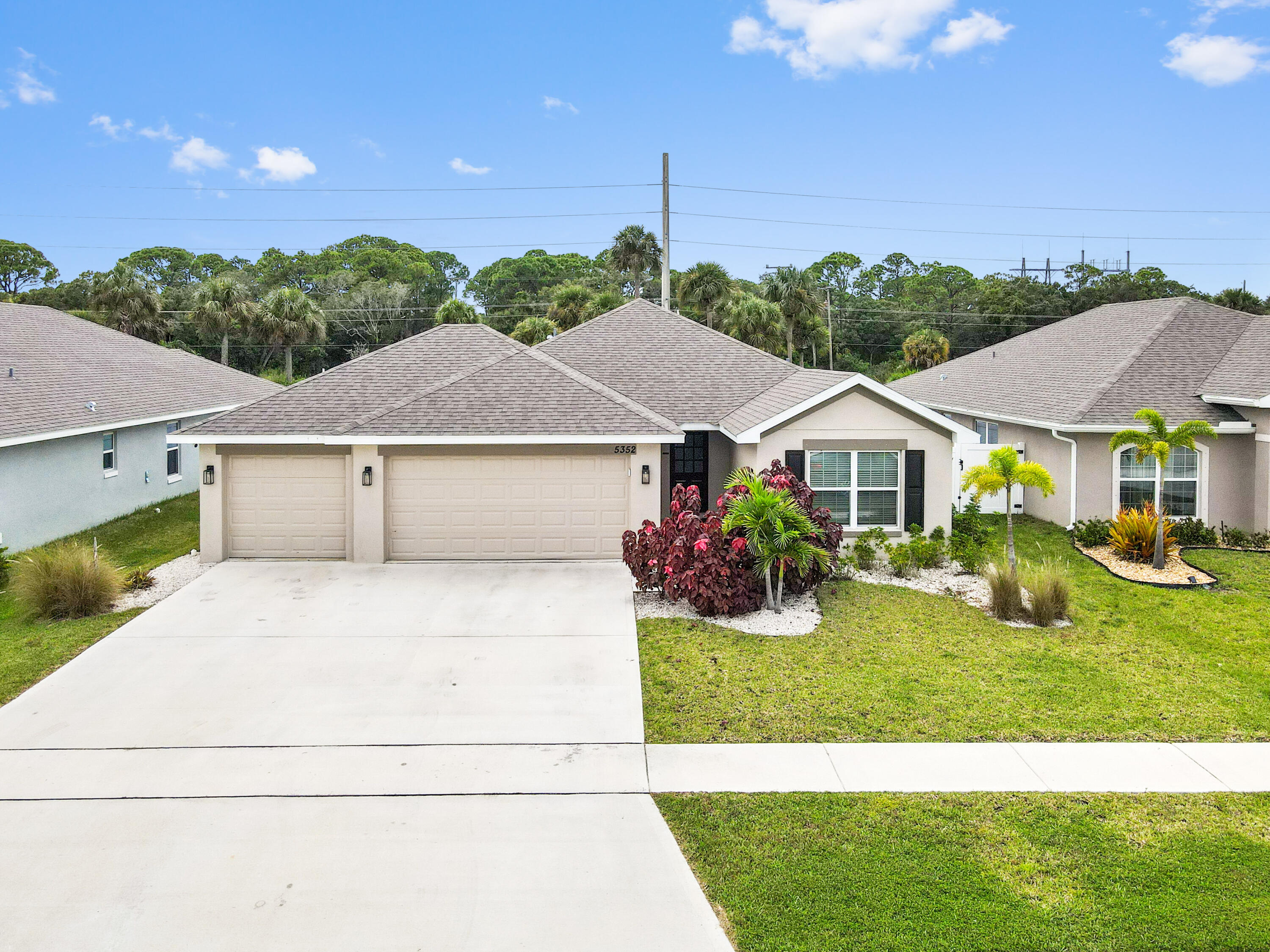 5352 Lugo Street Fort Pierce, FL 34951 - Photo 1 of 44 a front view of a house with garden