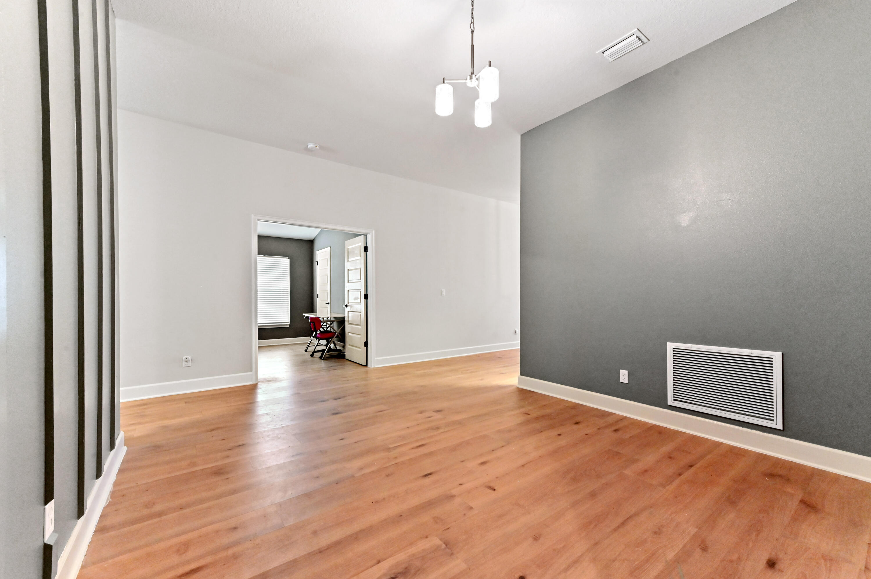 5352 Lugo Street Fort Pierce, FL 34951 - Photo 11 of 44 a view of a livingroom with wooden floor and kitchen space
