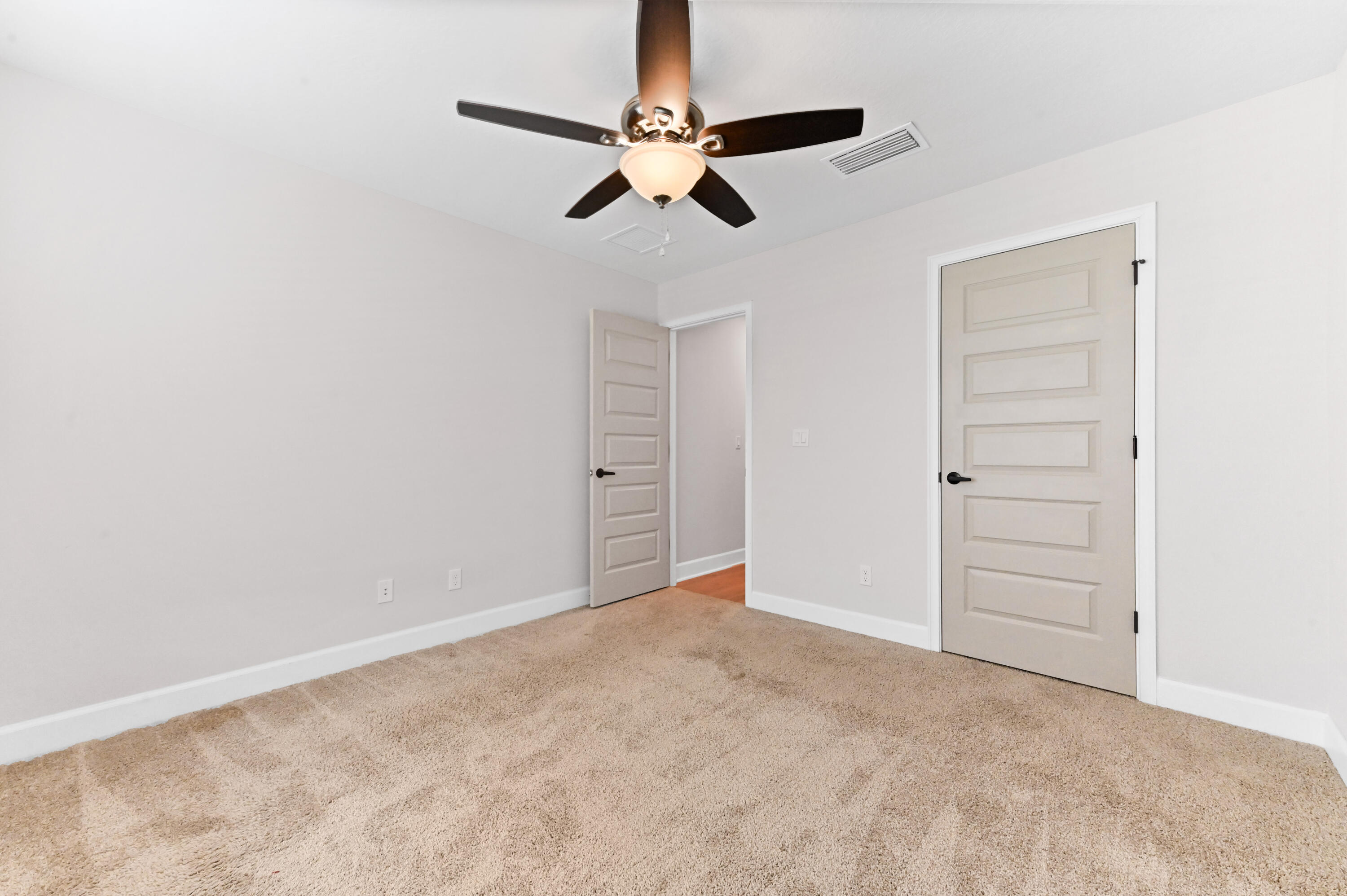 5352 Lugo Street Fort Pierce, FL 34951 - Photo 23 of 44 a view of an empty room with a ceiling fan