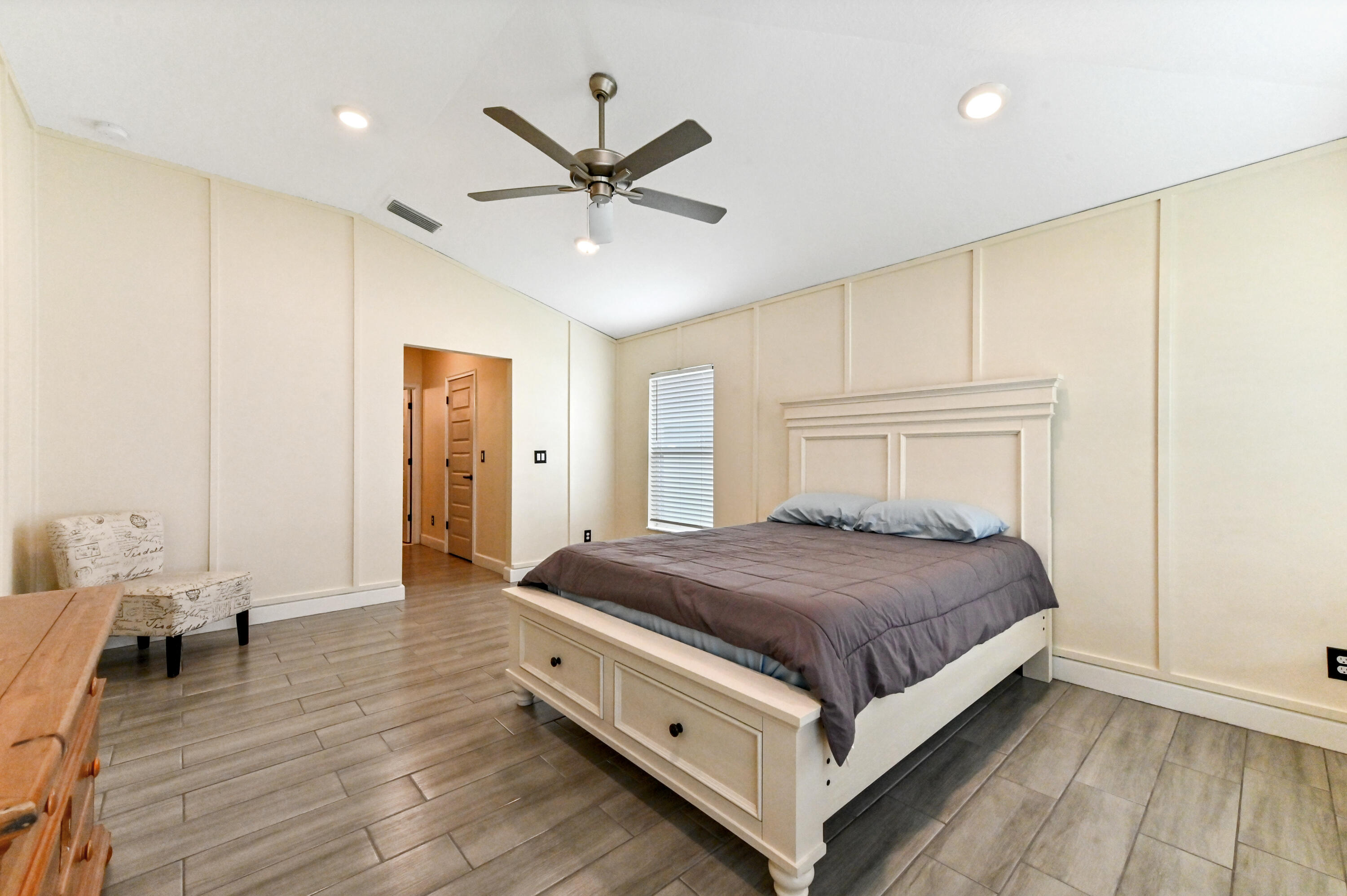 5352 Lugo Street Fort Pierce, FL 34951 - Photo 30 of 44 a bedroom with a bed and a chandelier