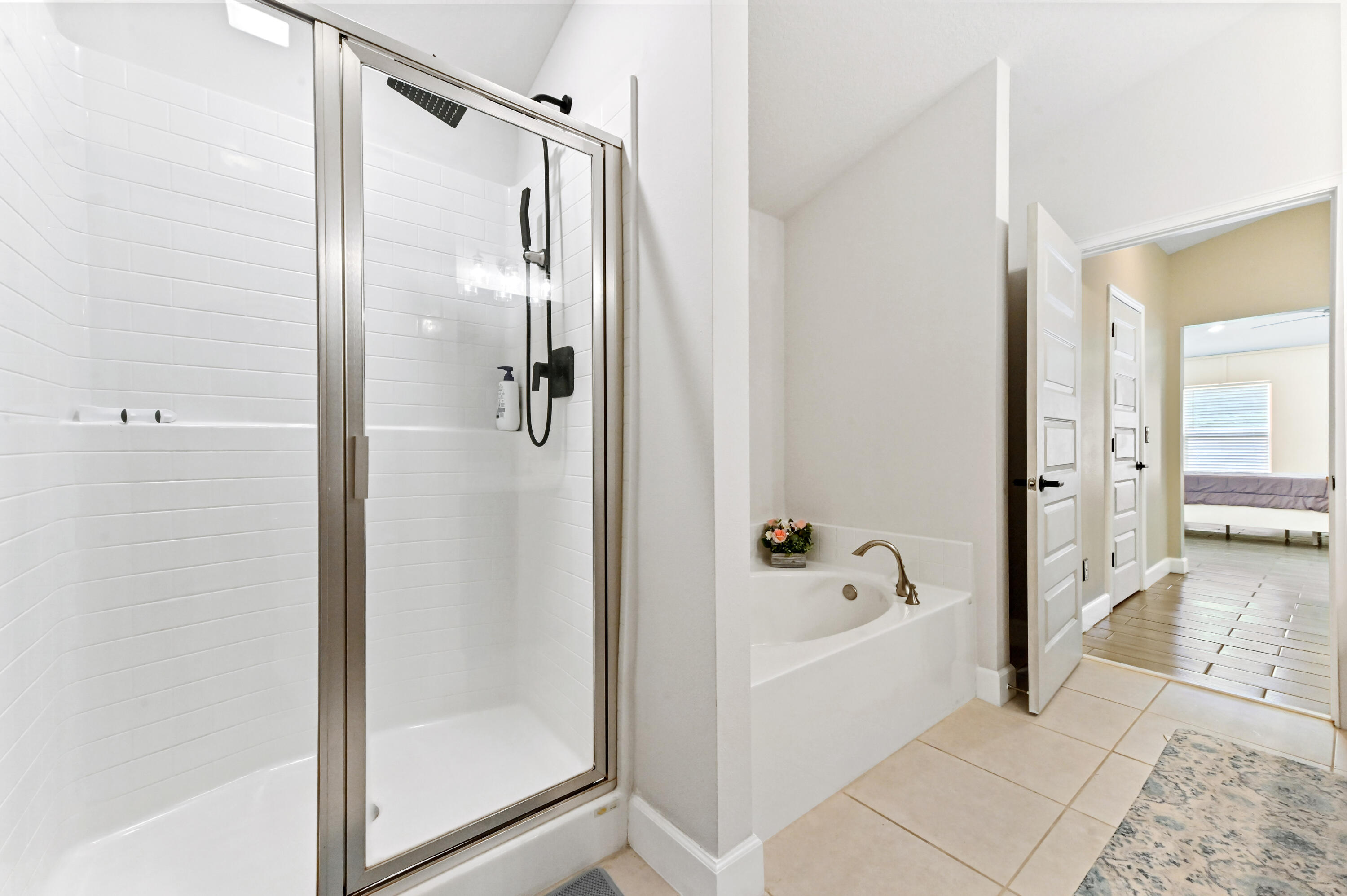 5352 Lugo Street Fort Pierce, FL 34951 - Photo 36 of 44 a bathroom with a glass shower door and a bath tub