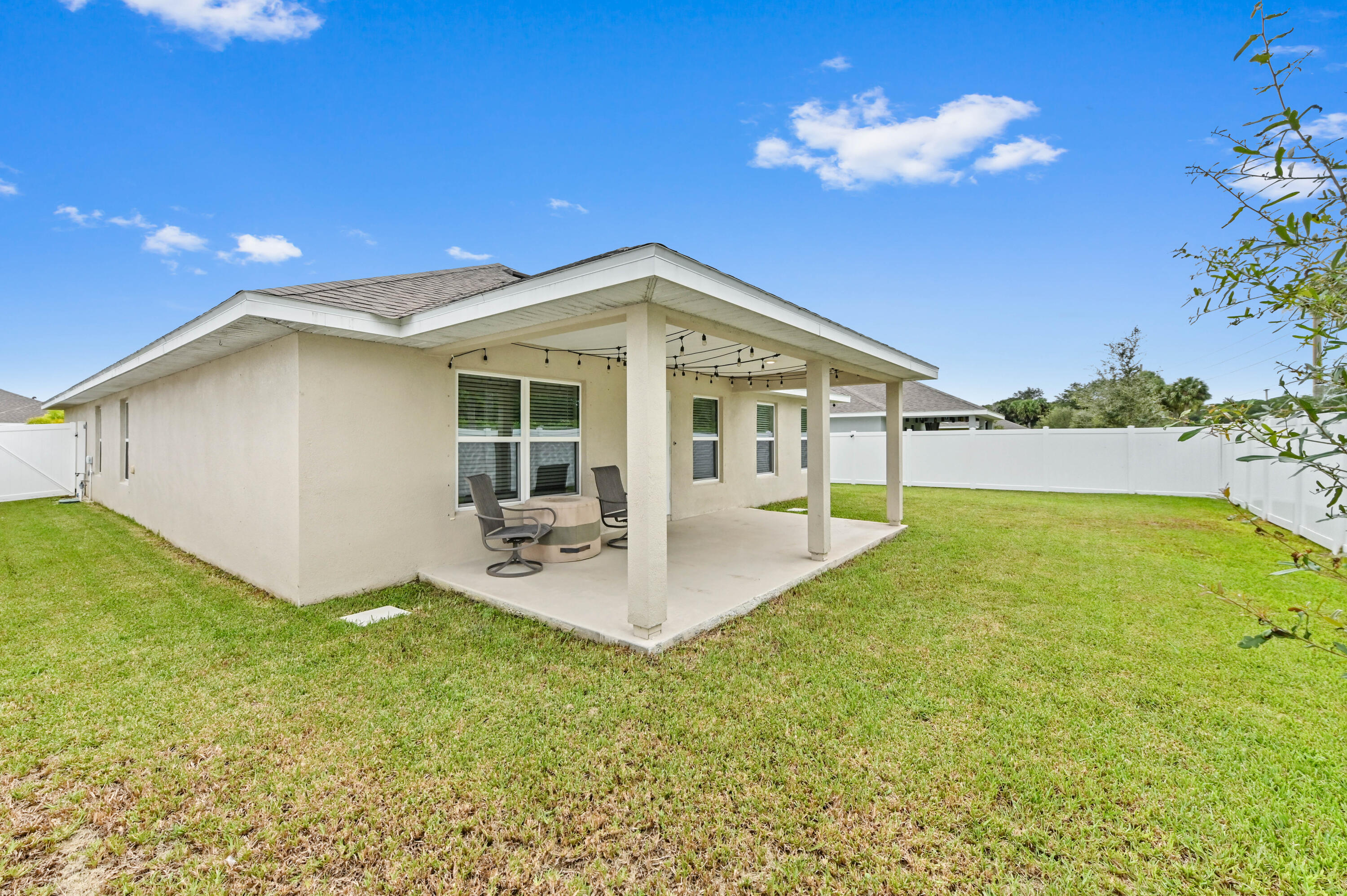 5352 Lugo Street Fort Pierce, FL 34951 - Photo 38 of 44 a view of a house with backyard porch and patio