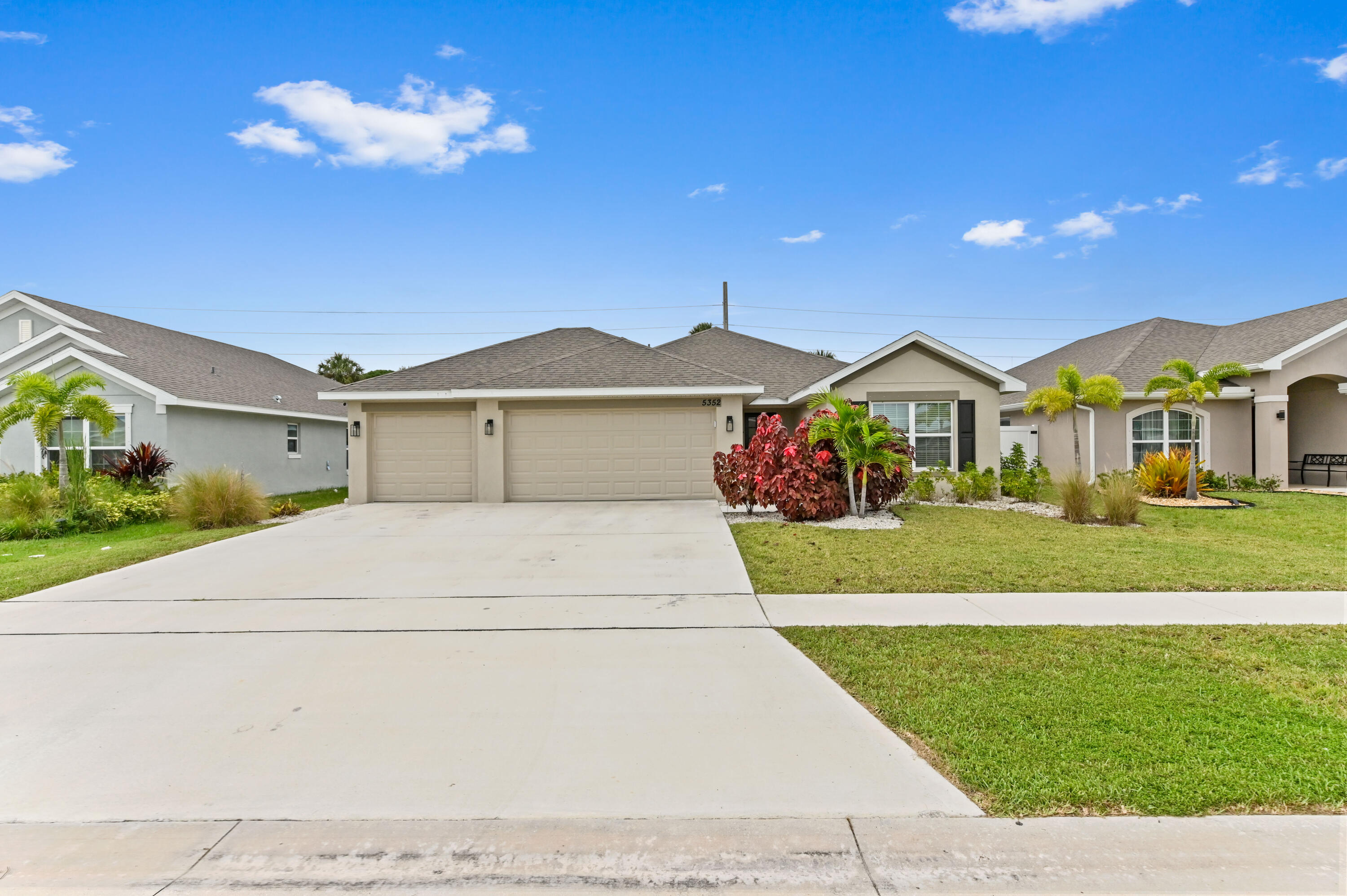 5352 Lugo Street Fort Pierce, FL 34951 - Photo 4 of 44 a front view of a house with a yard