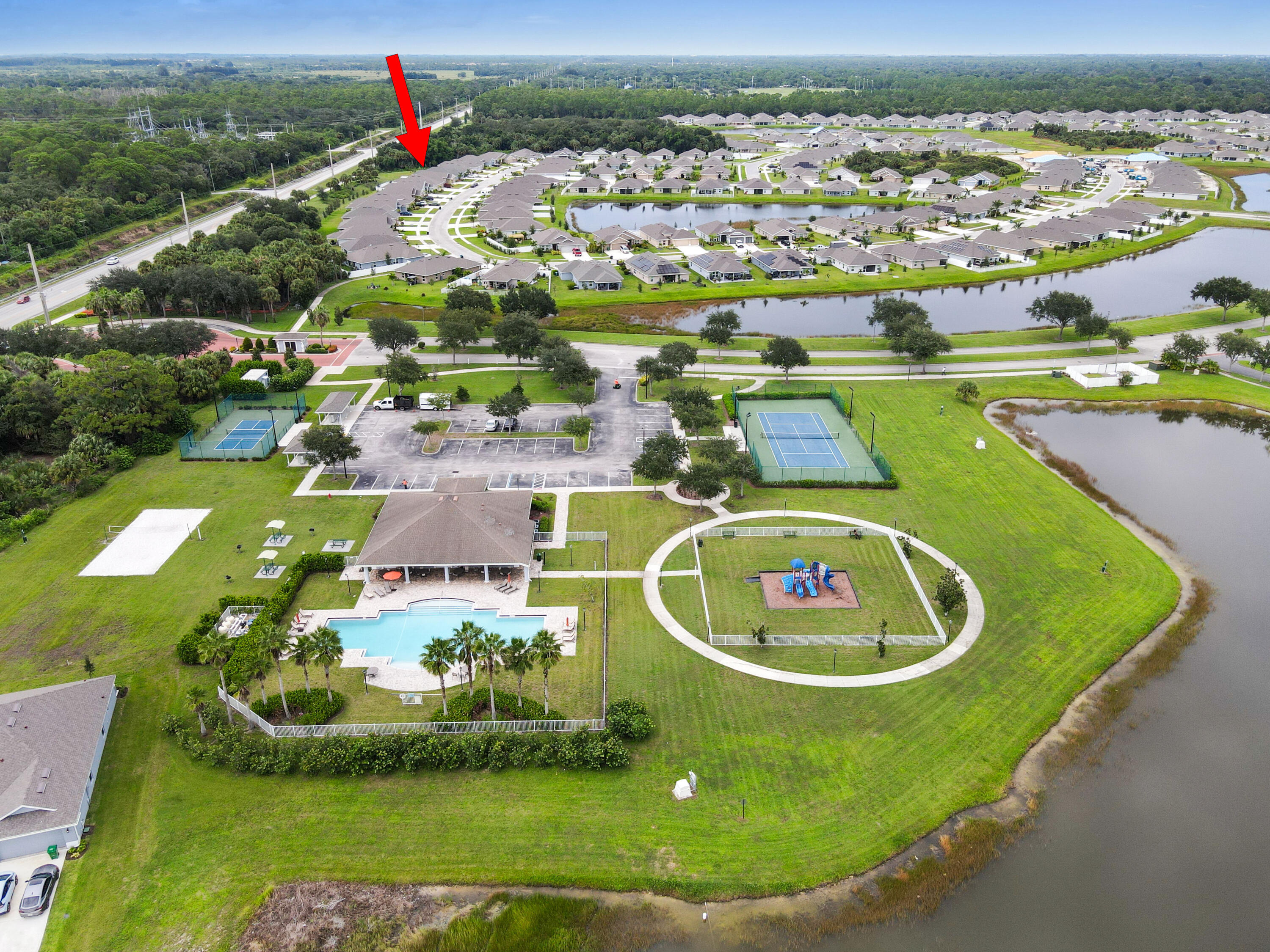 5352 Lugo Street Fort Pierce, FL 34951 - Photo 43 of 44 an aerial view of a house with a yard and lake view