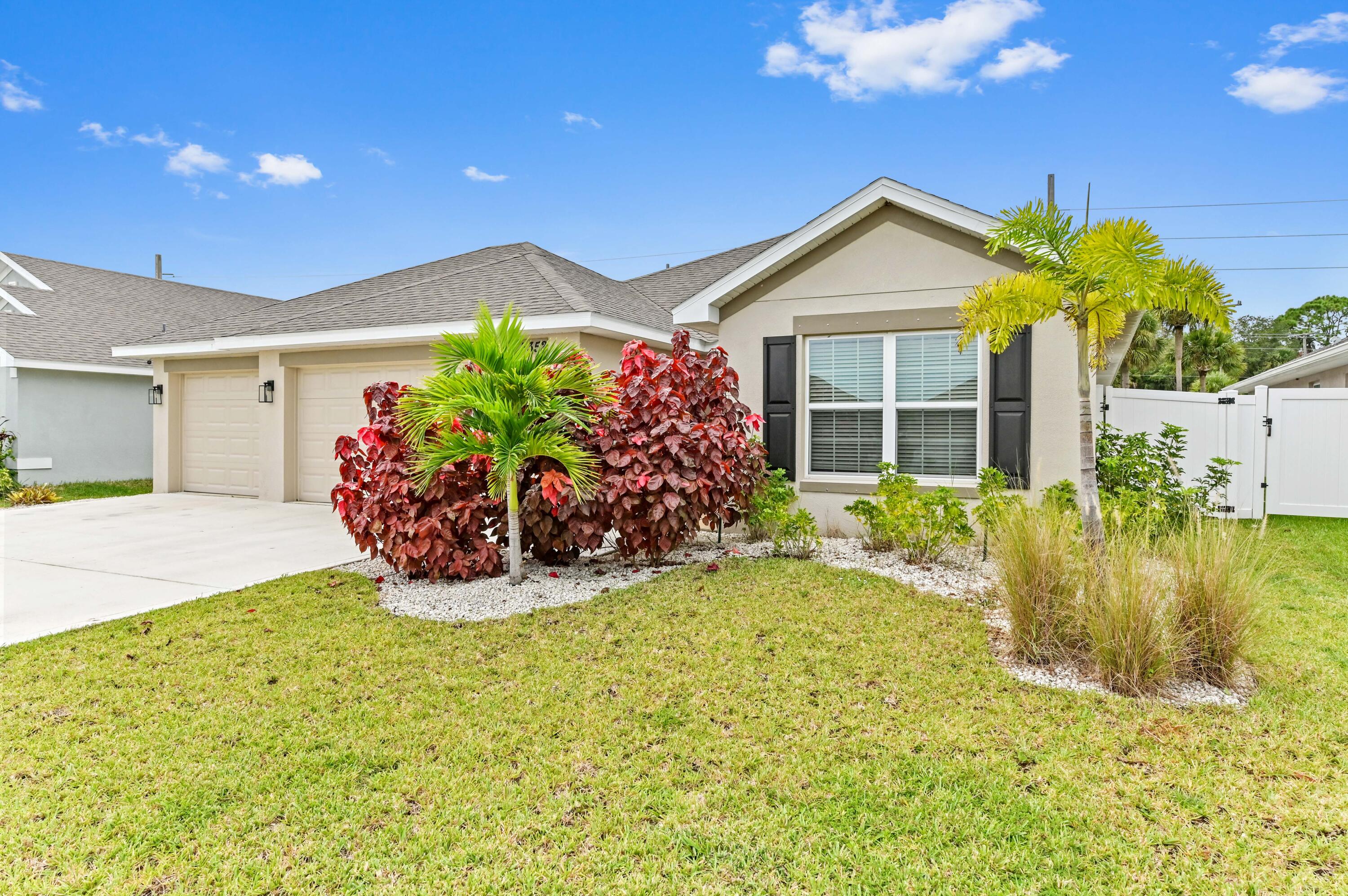 5352 Lugo Street Fort Pierce, FL 34951 - Photo 5 of 44 a view of a house with a yard and potted plants