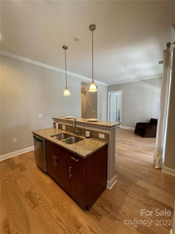 230 South Tryon Street, Unit 508 Charlotte, NC 28202 - Photo 11 of 24 a kitchen with stainless steel appliances granite countertop a stove a sink a refrigerator and white cabinets