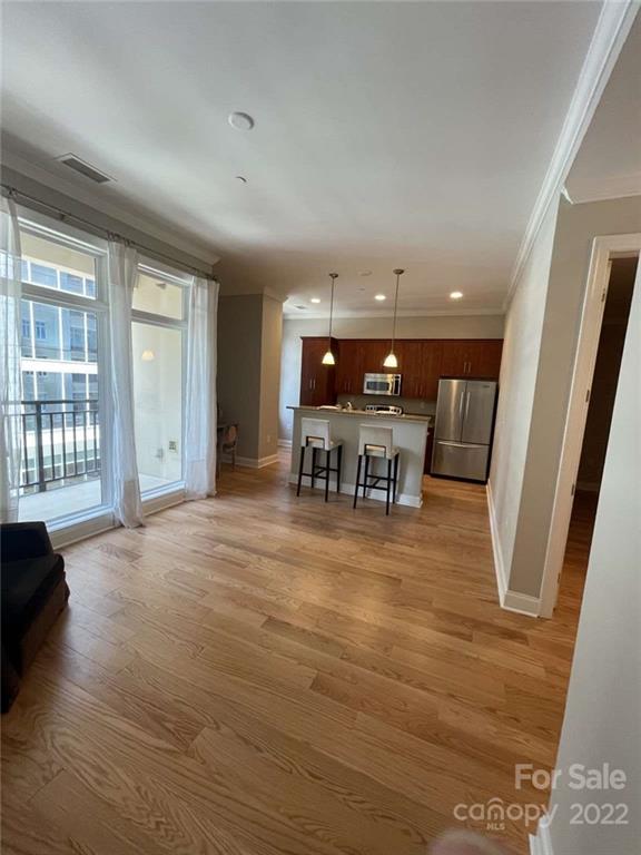 230 South Tryon Street, Unit 508 Charlotte, NC 28202 - Photo 12 of 24 a view of a big room with wooden floor and windows