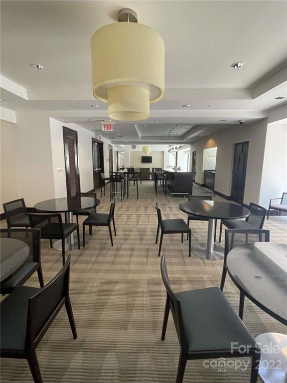 230 South Tryon Street, Unit 508 Charlotte, NC 28202 - Photo 17 of 24 a view of a dining room with furniture and a chandelier
