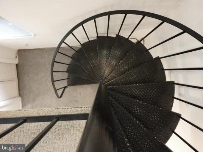 6216 Tramore Road Baltimore, MD 21214 - Photo 20 of 30 a close view of staircase with a dining table