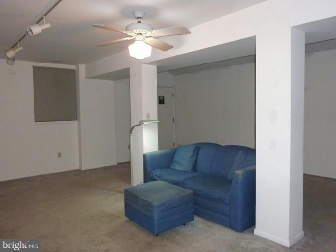 6216 Tramore Road Baltimore, MD 21214 - Photo 24 of 30 a living room with furniture and a chandelier