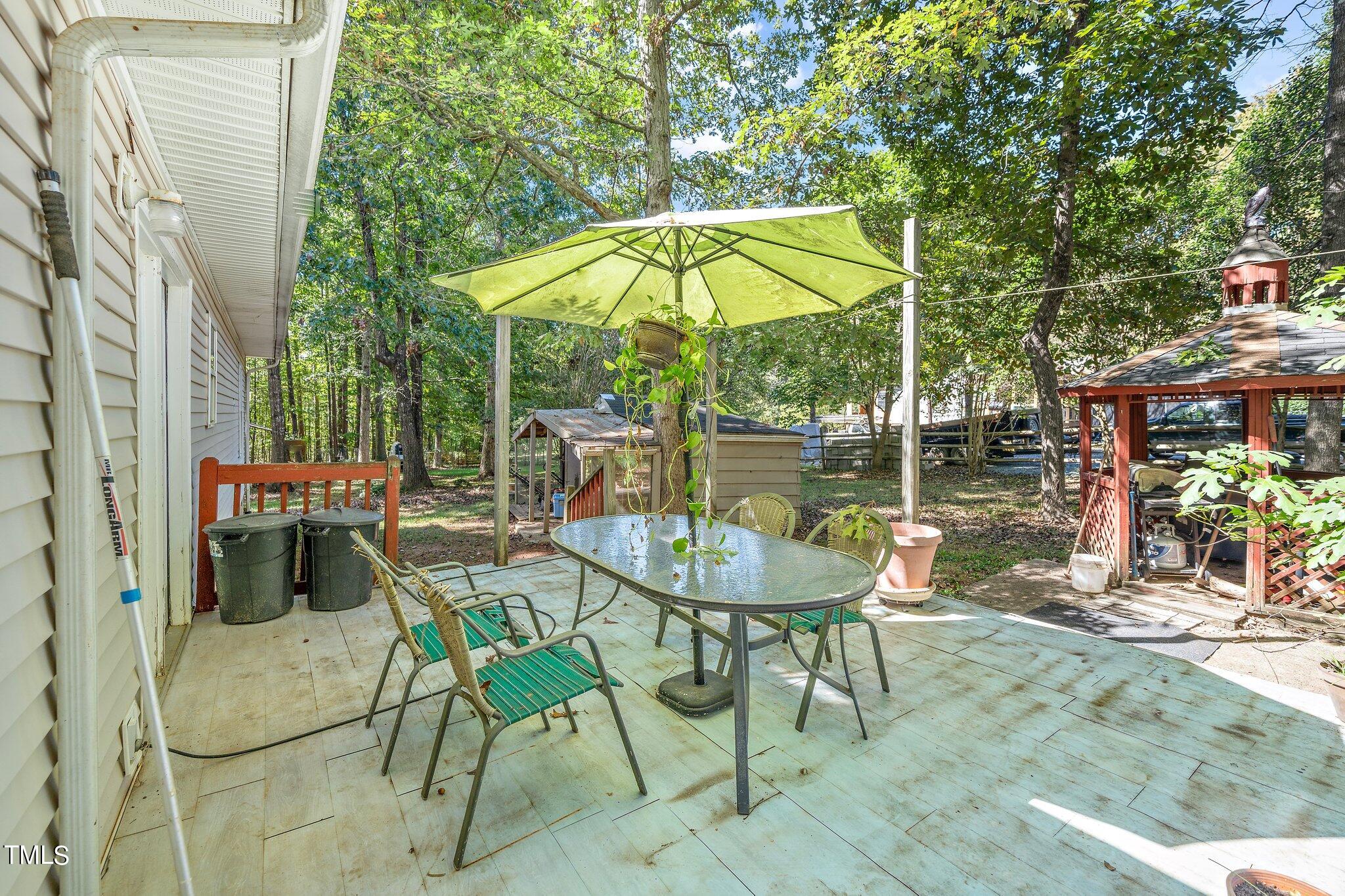 2514 Gemena Road Chapel Hill, NC 27516 - Photo 16 of 21 an outdoor space with furniture and umbrella