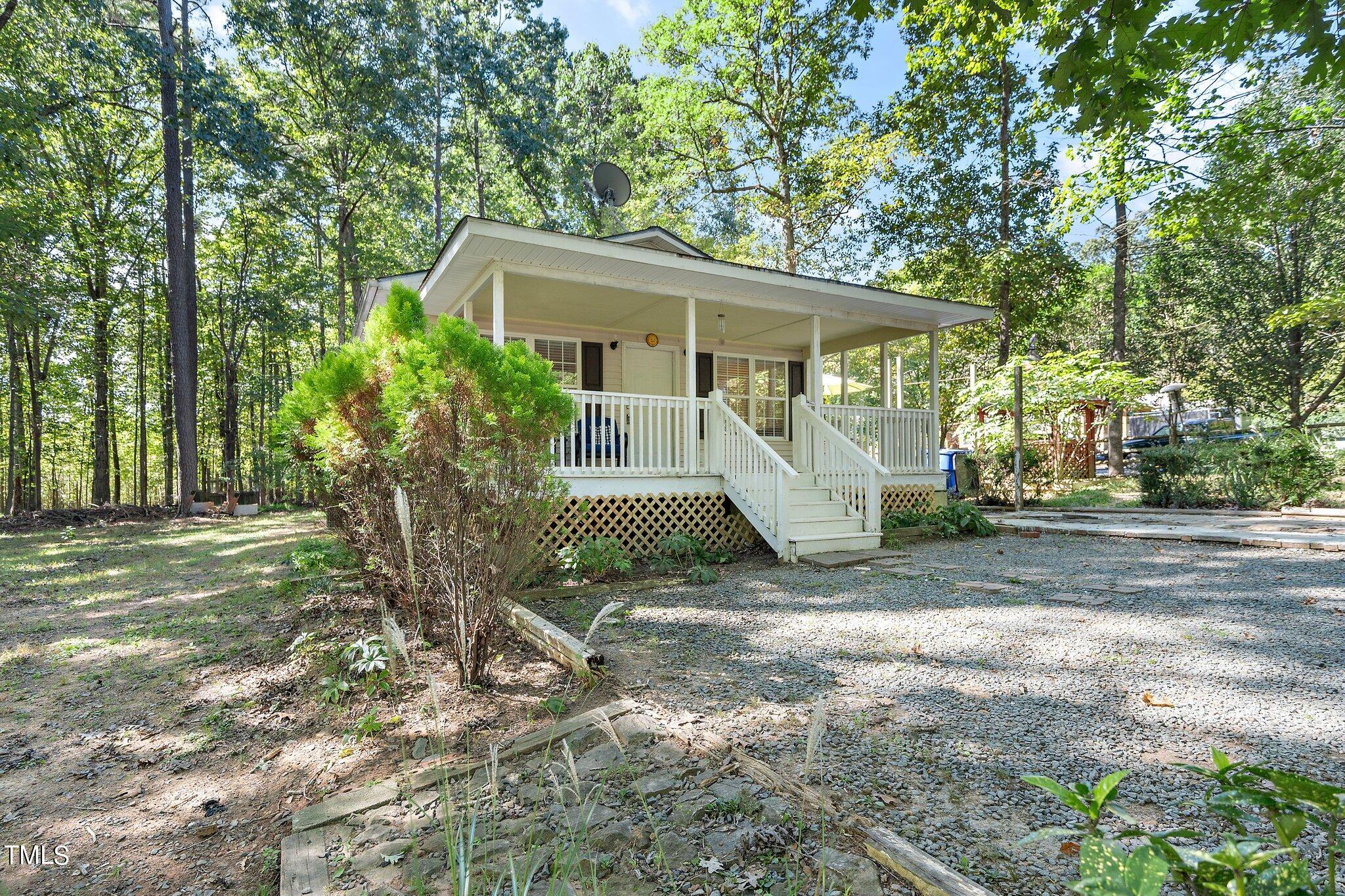 2514 Gemena Road Chapel Hill, NC 27516 - Photo 2 of 21 a view of a house with a tree in the yard