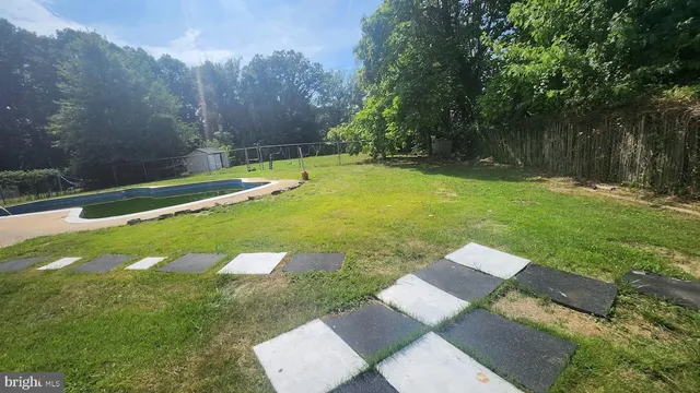 a view of a backyard with swimming pool