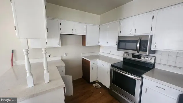 a kitchen with a sink and steel appliances