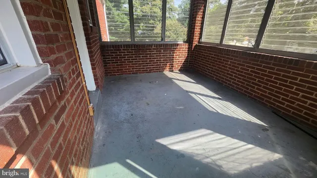 a view of a room with wooden floor and a window