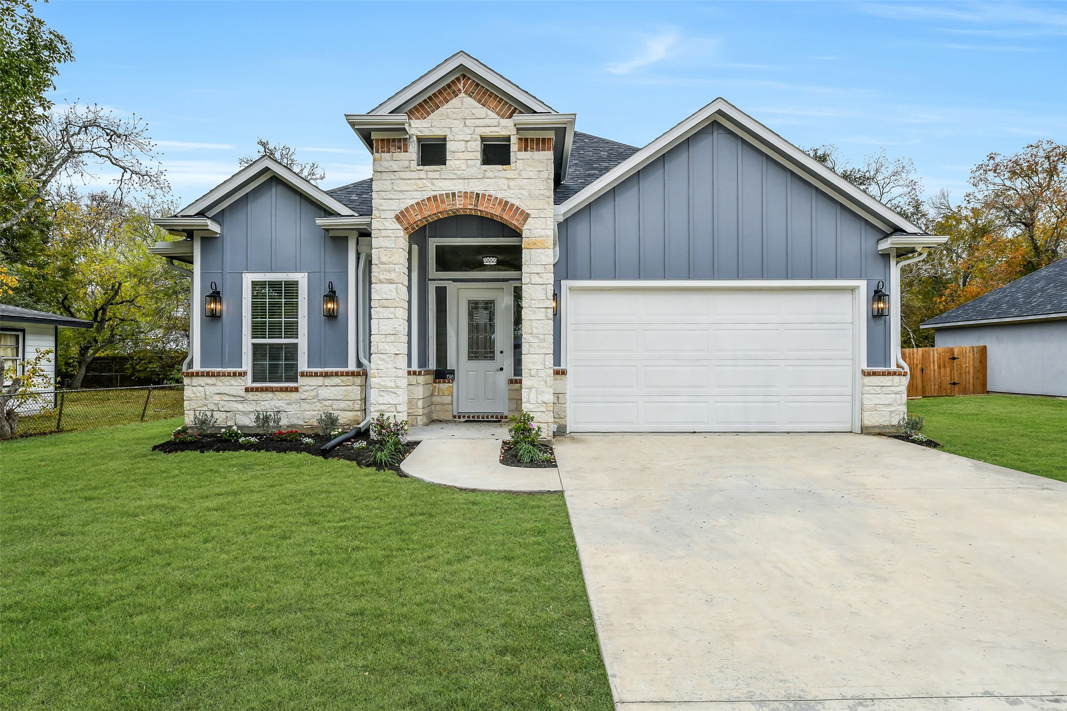 a front view of a house with a garden