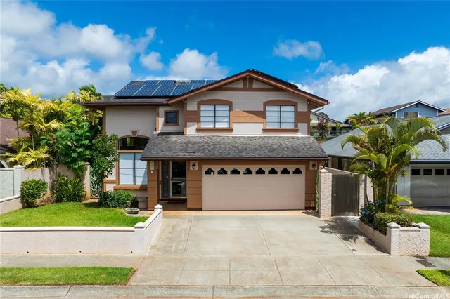 a front view of a house with a yard and garage