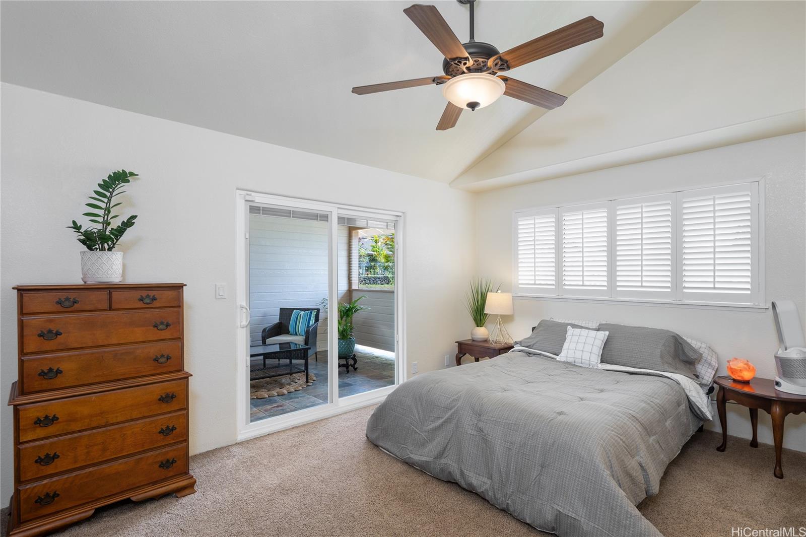 95-210 Kuauna Place Mililani, HI 96789 - Photo 11 of 25 a bedroom with a bed and a chandelier