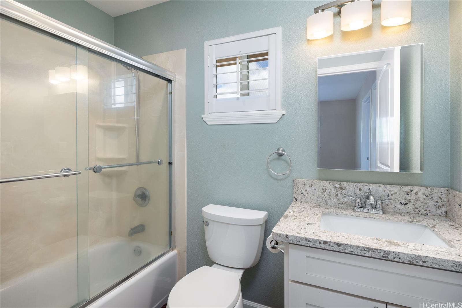 95-210 Kuauna Place Mililani, HI 96789 - Photo 19 of 25 a bathroom with a granite countertop sink toilet and shower