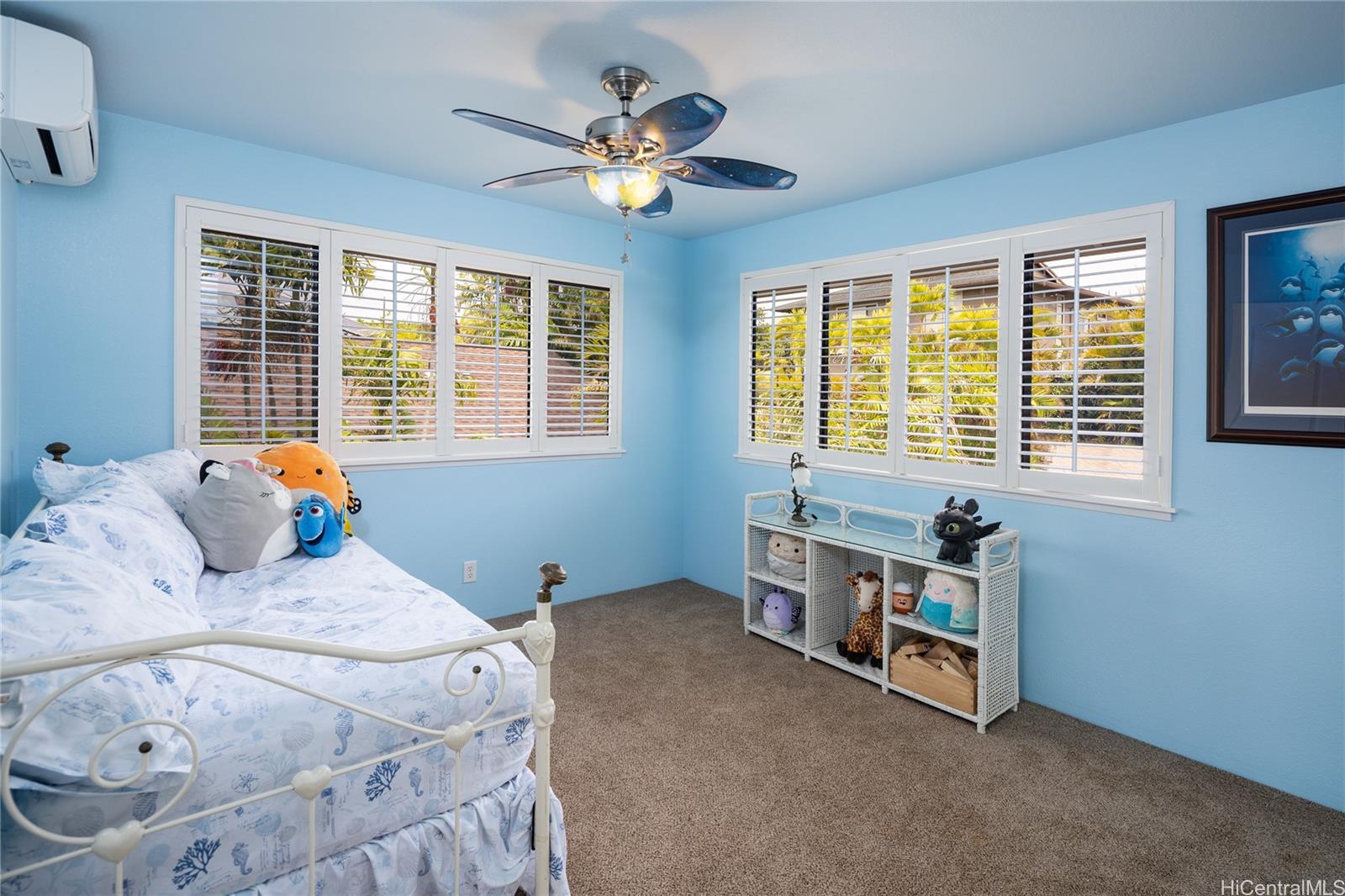 95-210 Kuauna Place Mililani, HI 96789 - Photo 9 of 25 a bed room with a bed and a chandelier